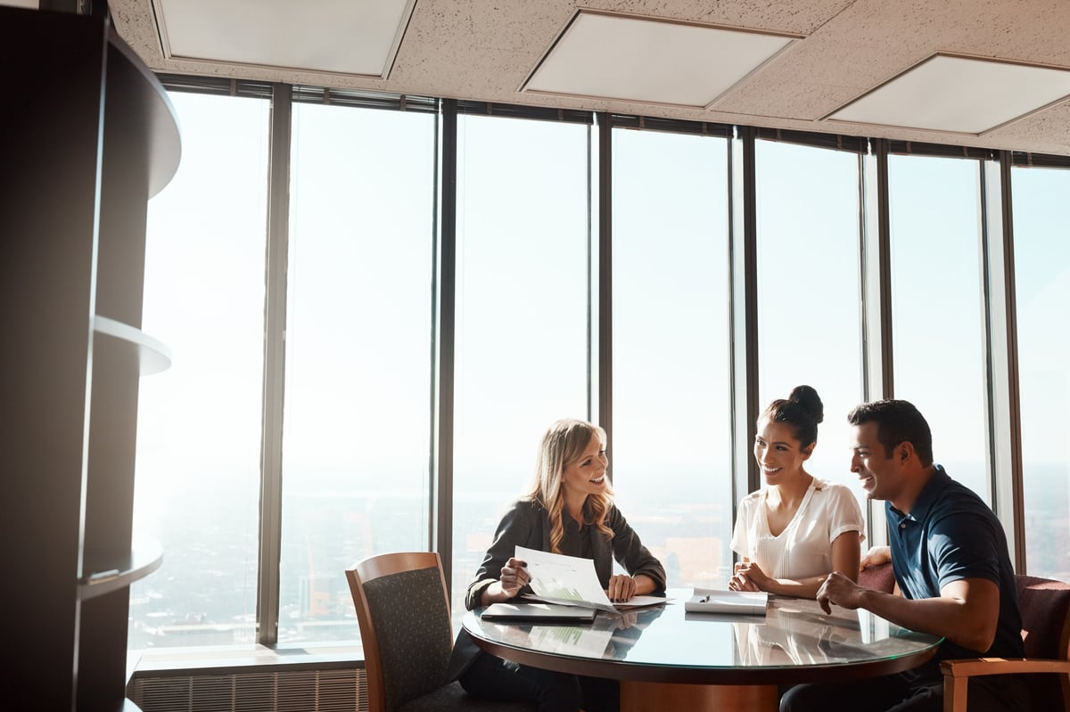 A young couple meeting with a financial planner in a modern office